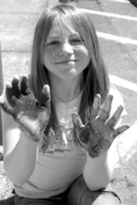 Carrie Parker basks in the chalky fun at last year's Langley Sidewalk Chalk Art Festival. Students and adults are invited to join the fun for the event's second year on Tuesday