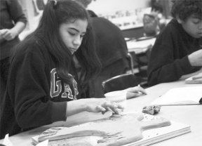 Langley Middle School seventh-grader Laura Hernandez concentrates on creating a clay bird that will be a part of a large tile wall mural honoring Martin Luther King