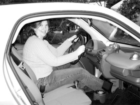 Green Car Company owner Susan Fahnestock sits in her personal SmartCar before her talk at The Exchange Monday night. Made in Germany by Mercedes-Benz and shaped like a tilted egg