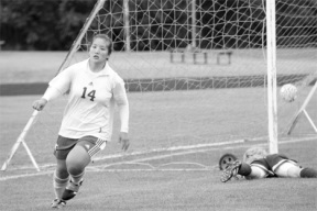 Grace Itaya calmly wheels away from Sequim’s goalie on Saturday as the girls soccer team powered to a 6-1 victory over the Wolves.