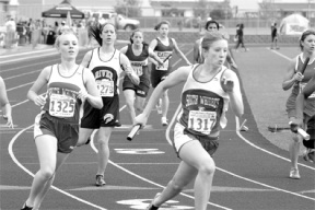 McKenzie Walker hands off the baton to Gwen Bakke on Friday in the relay team's effort to make the cut.
