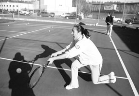 Jenny Saephan stretches for a baseline shot fired by Kylie Bozym during practice this week. Both players hope to qualify for the state tournament again this year.