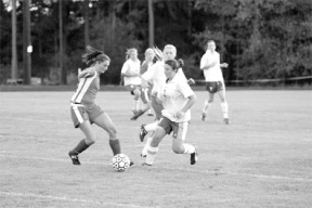 Jennifer Shafer mixes it up with a Wolf defender Thursday night during the Falcon’s second shutout over Coupeville