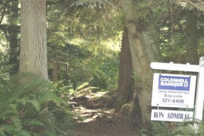 For sale signs were posted over the weekend on the seven acres adjoining the Wilbert Trail and the old growth forest at South Whidbey Island State Park. The asking price is $383