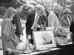 Attendees at last Saturday's Whidbey Island Center for the Arts auction look over items up for bid at the silent portion of the auction event.