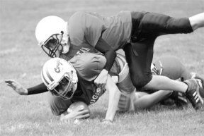 Langley Middle School running back Danny Zuver gets stopped cold early in the Cougar's 8-0 shutout of the Sultan Skyhawks. Zuver and company wrapped up a 5-1 season Tuesday with an unexpected defensive battle that kept Sultan off guard to the end.