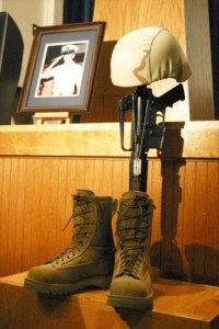 A "fallen soldier display" for EOD Chief Petty Officer Gregory John Billiter stands near the stage at Skywarriors theater in Oak Harbor during the memorial service Monday for three sailors who died in Iraq. Petty Officer 1st Class Joseph Adam McSween and Petty Officer 2nd Class Curtis Ralph Hall were also killed when a rocket hit the trio's Humvee while they were on patrol in Hawijah