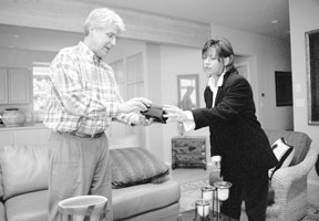 Rick Elliott shows off an imported box to Web designer Carrie McDougall. The two South Whidbey business people launched a new Web site in September on which people can sell their used furniture.
