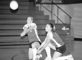 Nici Eaton comes up with a low ball as she and Lucy Daumen go to the floor in the first game of Thursday's home match with Blaine.