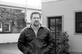 Businessman Steve Myres stands in front of two buildings he purchased recently on Main Street and