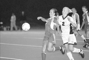 Jaci Gutzmer uses her whole body to keep the ball in play Saturday night during a playoff game against Blaine.