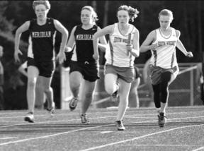 Katie Watson makes the first handoff to Sarah Olson in the girls 4x100 relay Thursday.
