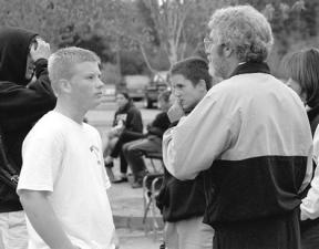 South Whidbey High School Tennis Coach Tom Kramer lays it on the line for Todd Berry before his third and deciding set.