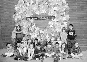 Students from Debra Davies' kindergarten class pose with South Whidbey Primary School's thankful wreath that students created in honor of Thanksgiving.