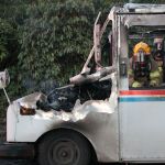 Kyle Jensen / The Record                                Firefighters examine the extent of the damage to the mail truck.