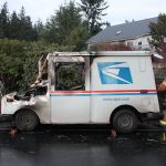 Kyle Jensen / The Record                                A firefighter pulls charred mail from the rear of the mail truck.