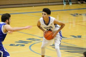 Evan Thompson / The Record                                Falcon junior point guard Lewis Pope looks for an opening against Bellevue Christian&rsquo;s defense on Saturday night. The Falcons lost 52-40.