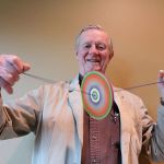 Kyle Jensen / The Record                                Rufus Rose spins one of his colored branch spinners by pulling the strings apart, adding tension.