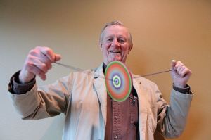 Kyle Jensen / The Record                                Rufus Rose spins one of his colored branch spinners by pulling the strings apart, adding tension.