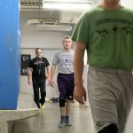 Evan Thompson / The Record                                Wrestlers Logan Madsen, Hunter Newman, and head coach Jim Thompson leave the boys athletic locker room and head off to practice Thursday afternoon. The locker room has been cold the last two years until the South Whidbey School District made repairs this week, though the fix is only temporary.
