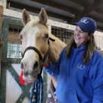 Kyle Jensen / The Record                                Whidbey Wranglers leader Erin Hanson laughs after Becca, a white Quarter Horse, seems happy after being brushed.