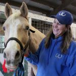 Kyle Jensen / The Record                                Whidbey Wranglers leader Erin Hanson laughs after Becca, a white Quarter Horse, seems happy after being brushed.