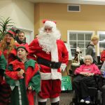 Kyle Jensen / The Record                                Santa and his elves sing Christmas carols in front of the crowd at Maple Ridge Assisted Living in Freeland.