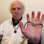 Kyle Jensen / The Record                                Bayview resident Joseph Kleinman holds up one of his many ancient coin pendants. He wears one every day that depicts Adrian from Alexandria, who he admires for the way he changes provinces in the Roman Empire.