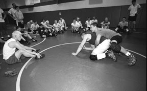 Nick Martinovic and Todd Noste get technique instruction from Falcon’s assistant coach Wes Helseth