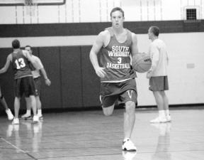 Senior post Brandon Turner brings the ball down the court in a preseason practice game last week. Though big at 5-11