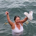 Kyle Jensen / The Record                                Admirals Cove resident Bonnie Nichols was brave enough to bare the chilly waters off Seawall Park. She beat a group of teenagers to the colorful sea float she took home.