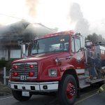 Kyle Jensen / The Record                                The first fire engine to respond to the Freeland house fire sprays the house.