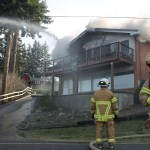 Kyle Jensen / The Record                                Firefighter Alex McMahon (right) scrambles to put out the fire while Chief Rusty Palmer oversees operations.