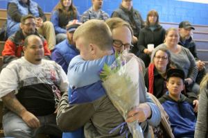 Evan Thompson / The Record &mdash;                                South Whidbey head wrestling coach Jim Thompson hugs senior Hunter Newman prior to the Falcons&rsquo; senior night match against Granite Falls on Jan. 11 at Erickson Gymnasium.