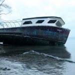 Kyle Jensen / The Record &mdash; A 50-foot fiberglass vessel, &ldquo;Liberty,&rdquo; grounded at Brighton Beach Tuesday morning after a month-long period of drifting in Puget Sound.