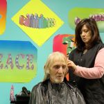 Stylist Spring Roehm trims the hair of Charles Jackson Thursday at Langley&rsquo;s Island Church. Free haircuts, a hot meal and other services were offered during the annual Homeless Point in Time count to encourage people in need of shelter to seek help. Volunteers also scoured Whidbey Island in search of the homeless.                                Photo by Patricia Guthrie/Whidbey News-Times