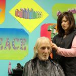 Photo by Patricia Guthrie/Whidbey News-Times                                Stylist Spring Roehm trims the hair of Charles Jackson Thursday at Langley&rsquo;s Island Church. Free haircuts, a hot meal and other services were offered during the annual Homeless Point in Time count to encourage people in need of shelter to seek help.