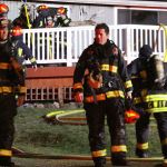 Capt. Jerry Helm, center, with Central Whidbey Fire & Rescue, walks away from a house where a man was found dead after a house fire in Coupeville Friday night. Photo by Ron Newberry/Whidbey News-Times