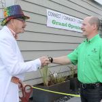 Evan Thompson / The Record &mdash; Mayor Tim Callison (left) shakes Whidbey Telecom co-CEO George Henny&rsquo;s hand during a ribbon cutting for the cable company&rsquo;s new satellite office, the BiG GiG Center.