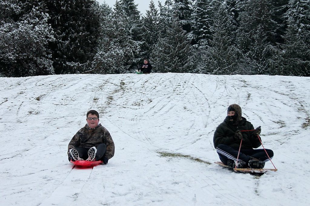 Kids swap books for boards, sleds and skis after Monday snowfall