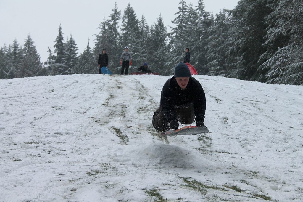 Kids swap books for boards, sleds and skis after Monday snowfall
