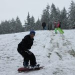 Kids swap books for boards, sleds and skis after Monday snowfall