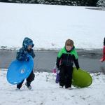 Kids swap books for boards, sleds and skis after Monday snowfall