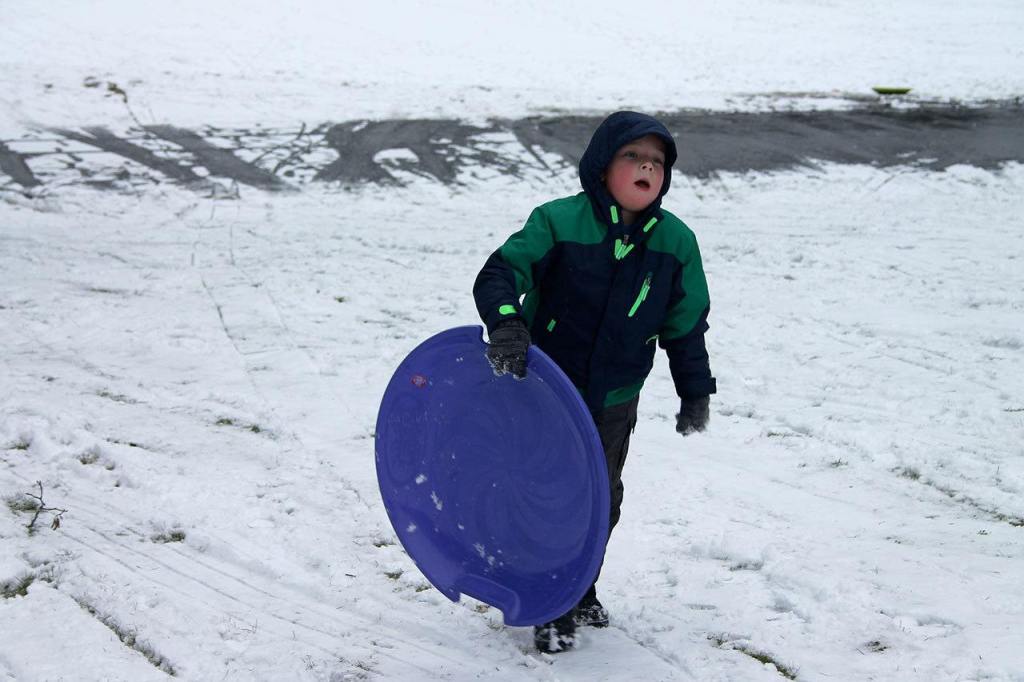 Kids swap books for boards, sleds and skis after Monday snowfall