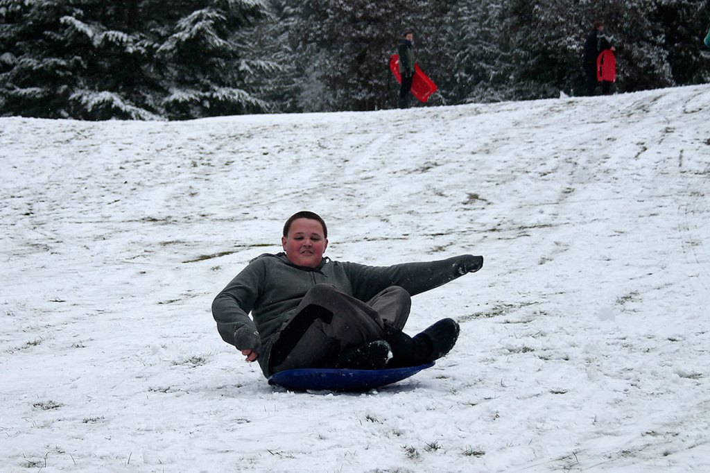 Kids swap books for boards, sleds and skis after Monday snowfall