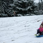 Kids swap books for boards, sleds and skis after Monday snowfall