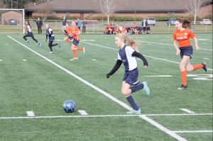 Bob Murnane photo &mdash; South Whidbey Reign player Mikenna Wicher leads an attack against Pacific FC Elite Club on Saturday, Jan. 28 in Vancouver, Wash. Wicher&rsquo;s teammates Adeline McCleary and Leniece Gonzales also move up the field to support Wicher&rsquo;s attack.