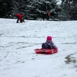 Kids swap books for boards, sleds and skis after Monday snowfall