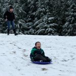 Kids swap books for boards, sleds and skis after Monday snowfall