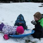 Kyle Jensen / The Record &mdash; While some focused on ripping downhill and picking up speed, others preferred the taste of the snow. Left to right: Summer Mozer, 2, Wesley Samuelson, 4, and Axton Mozer.